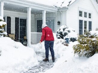 Snow removal service on residential walkway, winter landscaping, shoveling snow from home pathway, JCLawnscaping LLC.